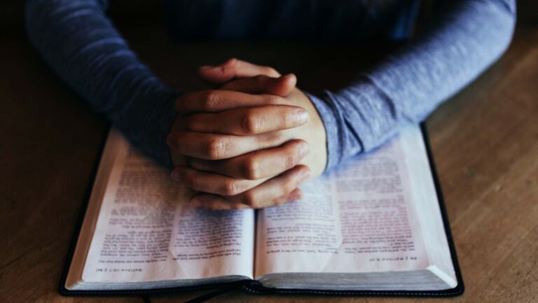 Man praying with open Bible